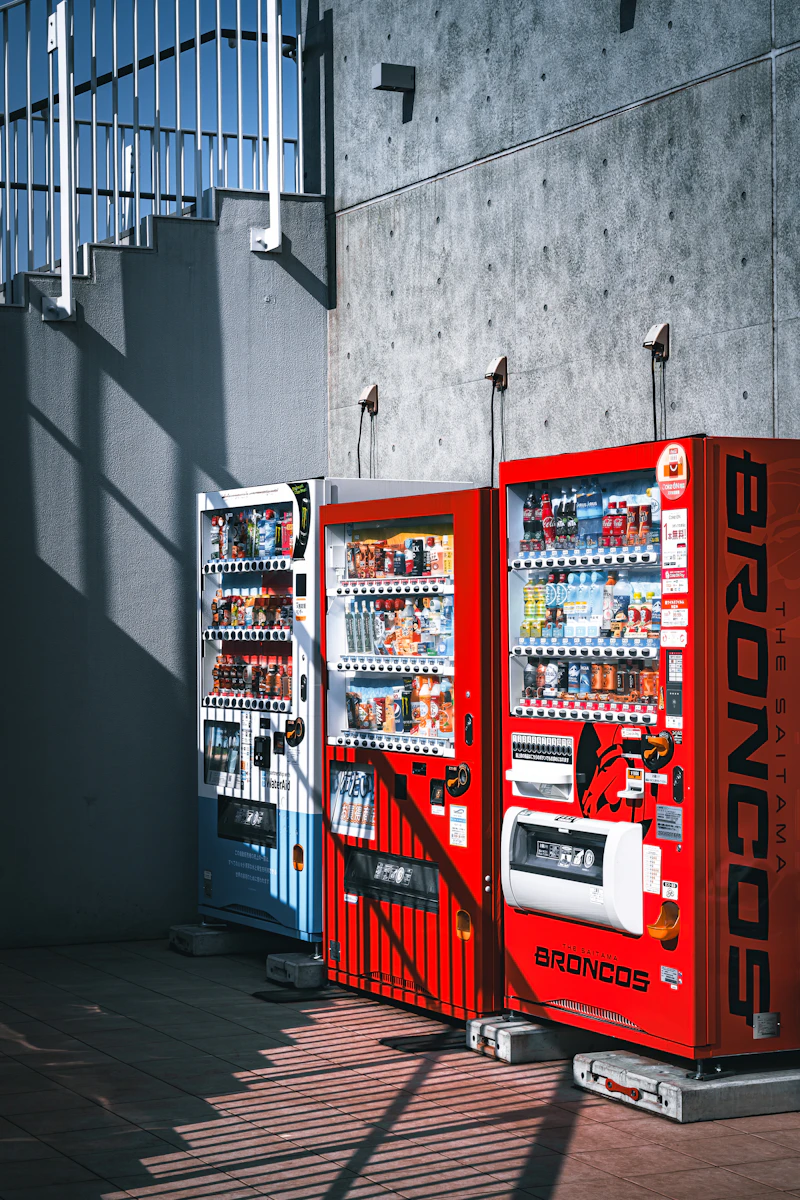 A row of Japanese vending machines on a city street in Japan, dispensing hot and cold beverages
