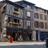 an old building with flower boxes on the windows