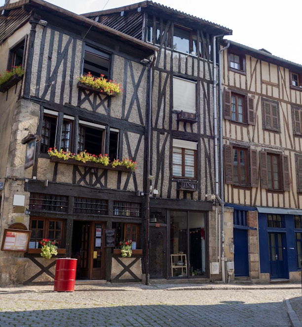 an old building with flower boxes on the windows