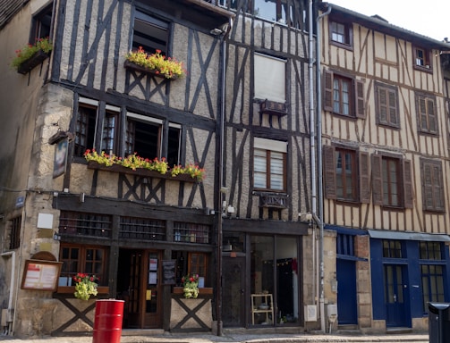 an old building with flower boxes on the windows