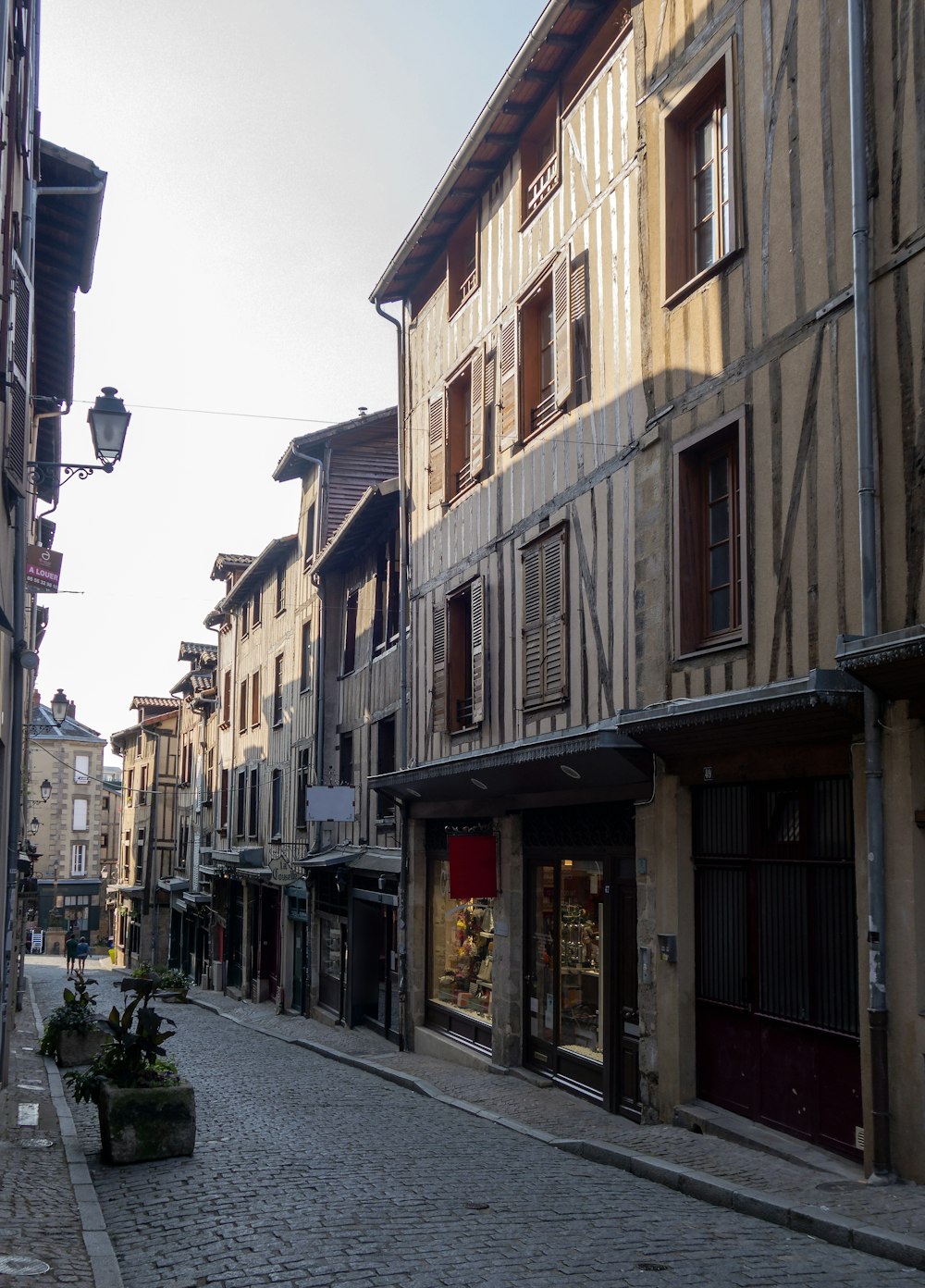 a cobblestone street lined with old buildings