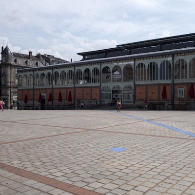 a group of people walking around a large building