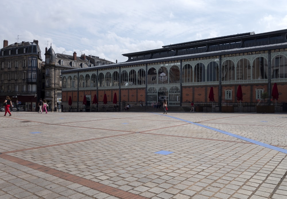 a group of people walking around a large building