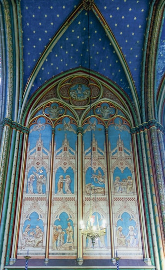 a church with a blue and white ceiling and a chandelier