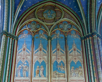 a church with a blue and white ceiling and a chandelier