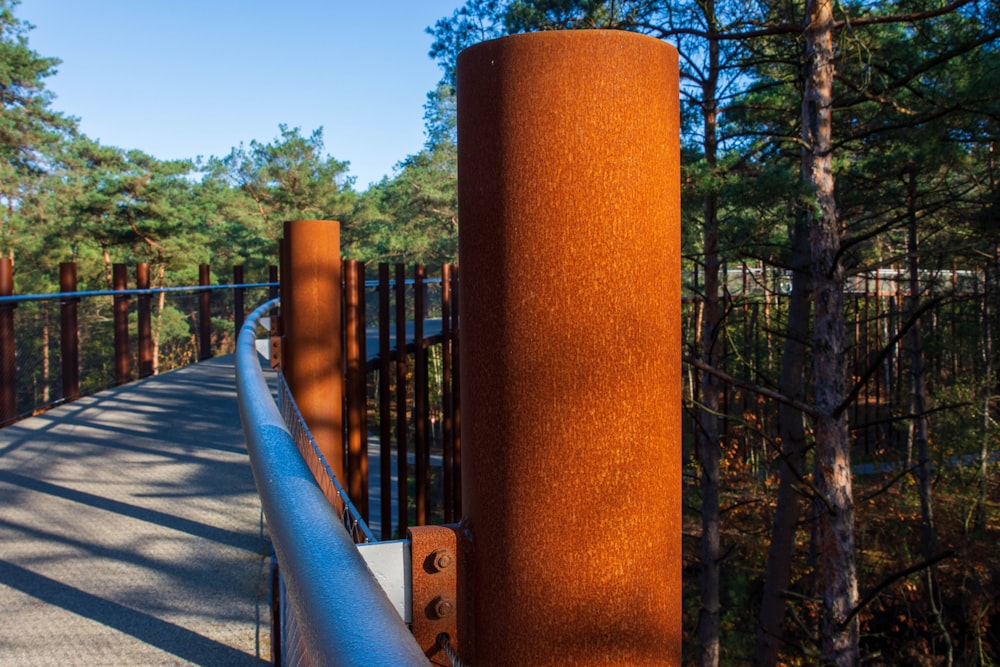 a tall metal pole sitting next to a metal fence