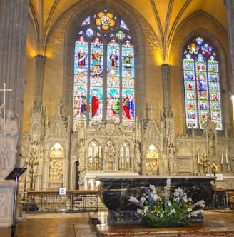 a large cathedral with stained glass windows and pews