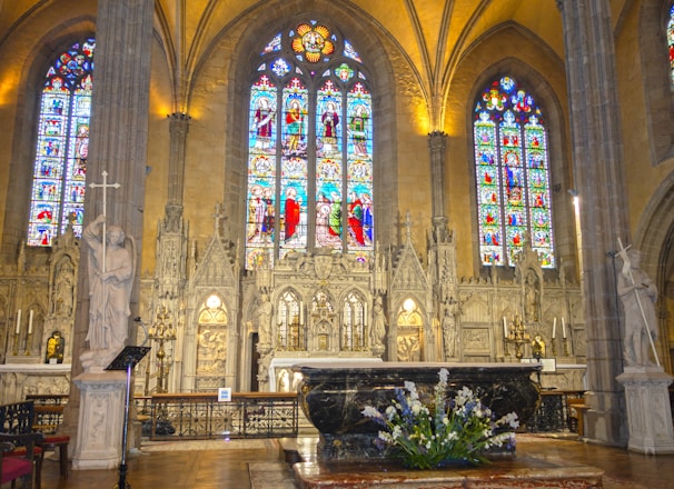 a large cathedral with stained glass windows and pews