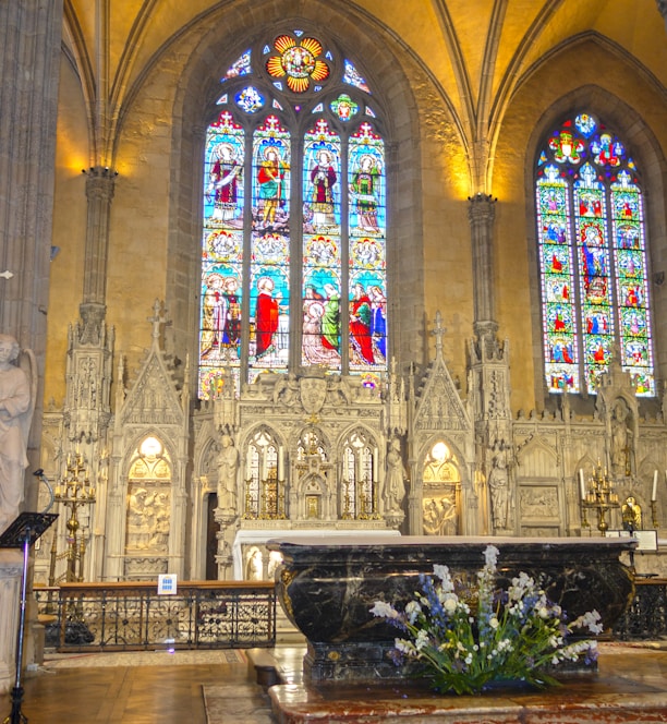 a large cathedral with stained glass windows and pews