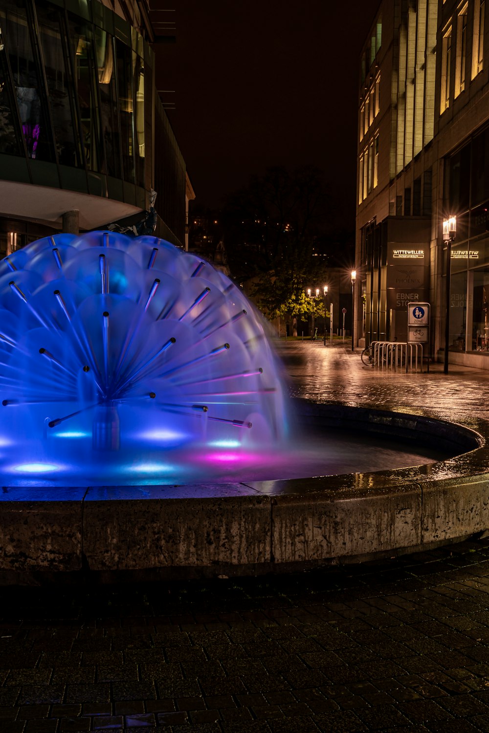 a fountain with a blue umbrella on top of it