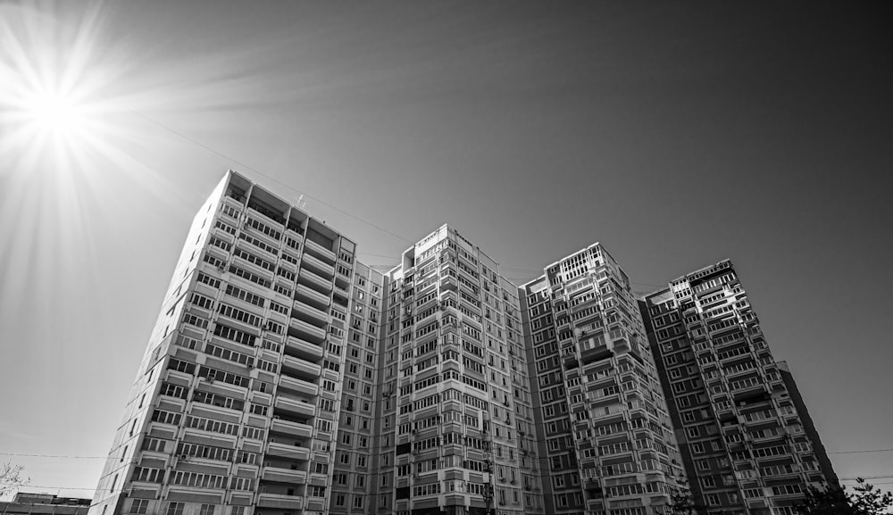 a black and white photo of a row of apartment buildings