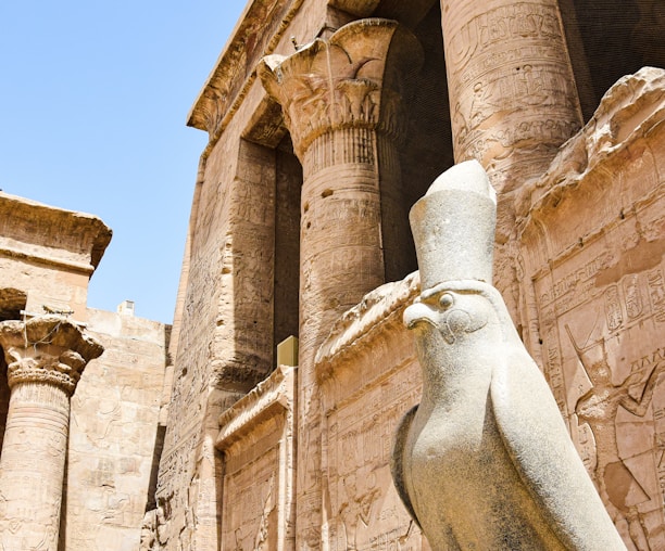 a statue of a bird in front of a building