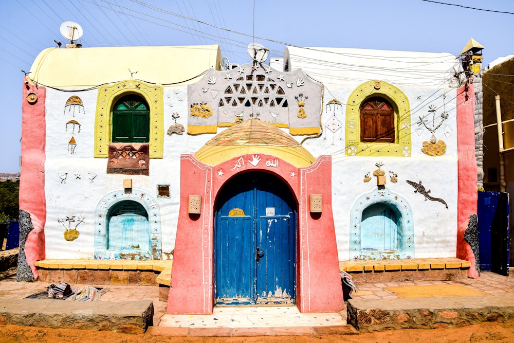 a colorfully painted building with a blue door