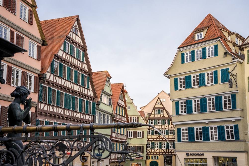 a row of buildings with green shutters on each of them