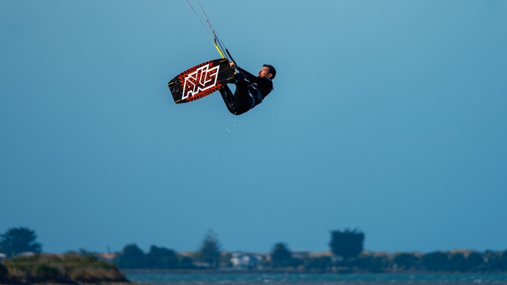 a man flying through the air while riding a kiteboard