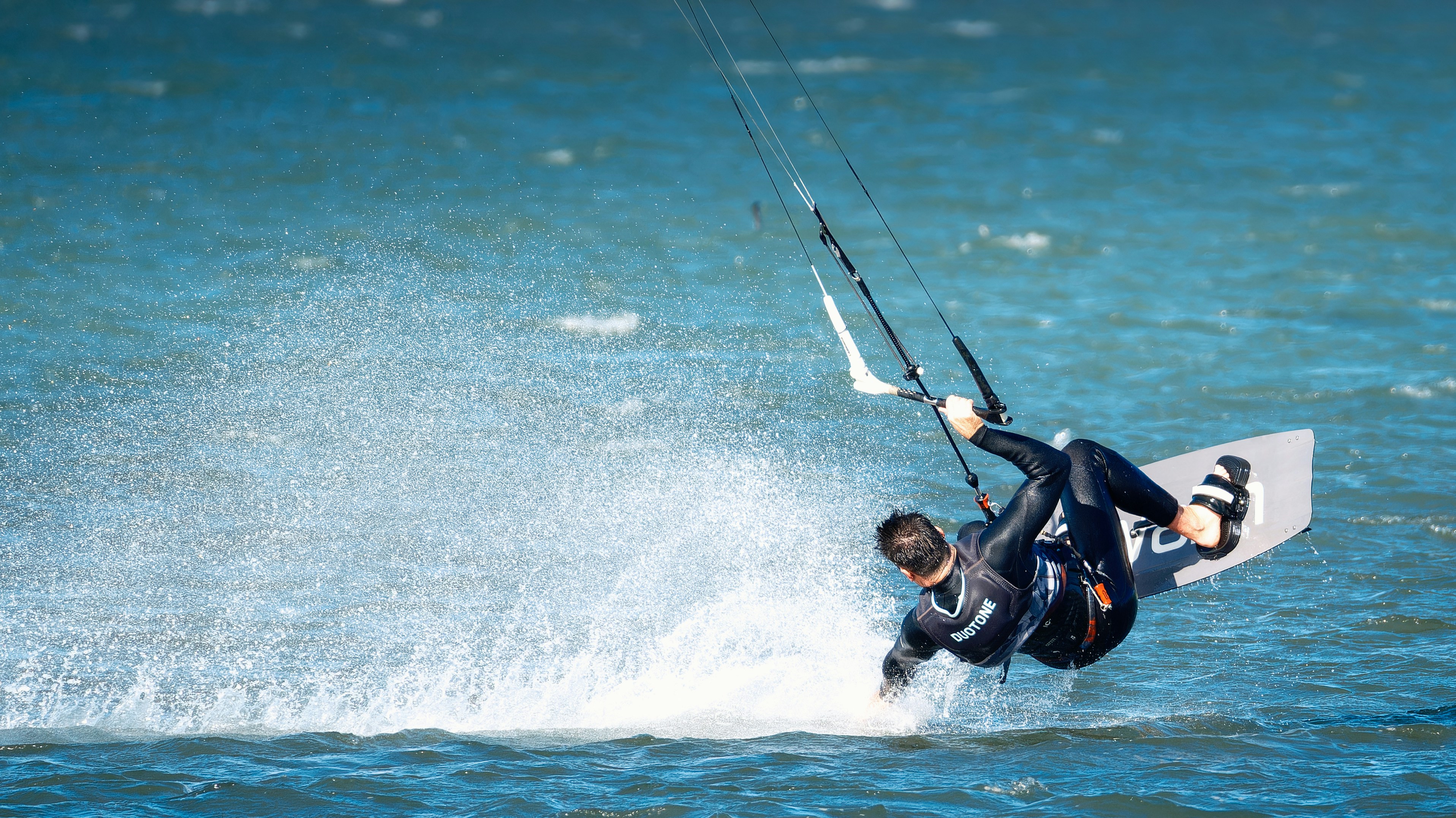 a man riding a kiteboard on top of a body of water