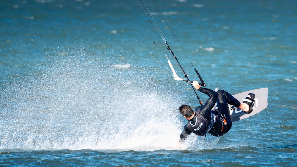 a man riding a kiteboard on top of a body of water