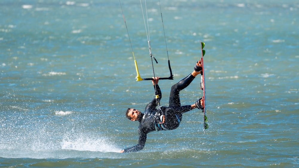 a man riding a kiteboard on top of a body of water