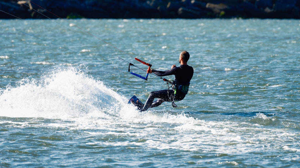 a man riding a kiteboard on top of a body of water