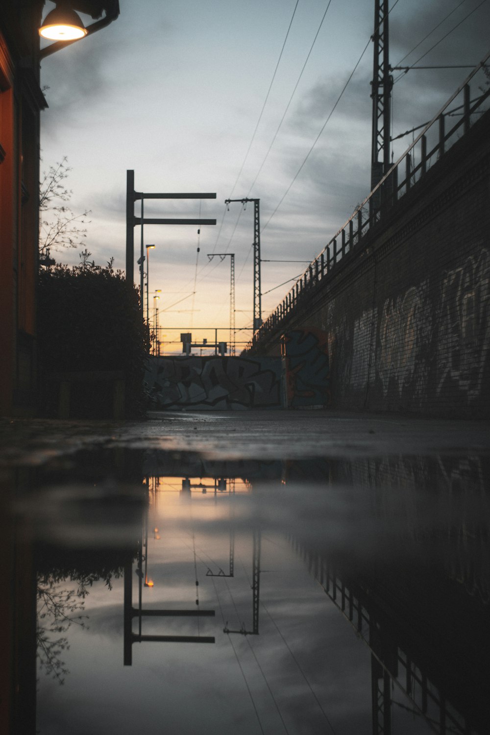 a reflection of a building in a puddle of water