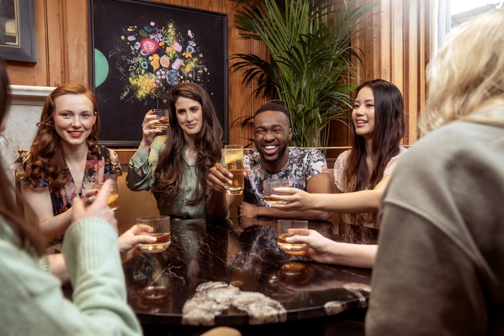 a group of people sitting around a table with drinks