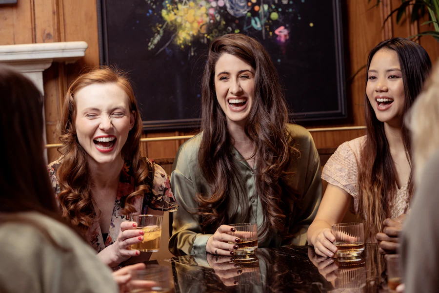 A group of women laughing together around a table