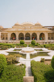 a large building with a fountain in front of it