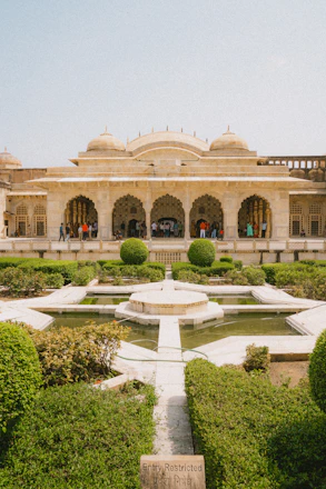 a large building with a fountain in front of it