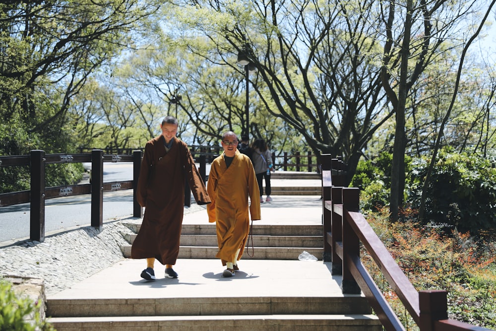 two monks walking down a set of stairs