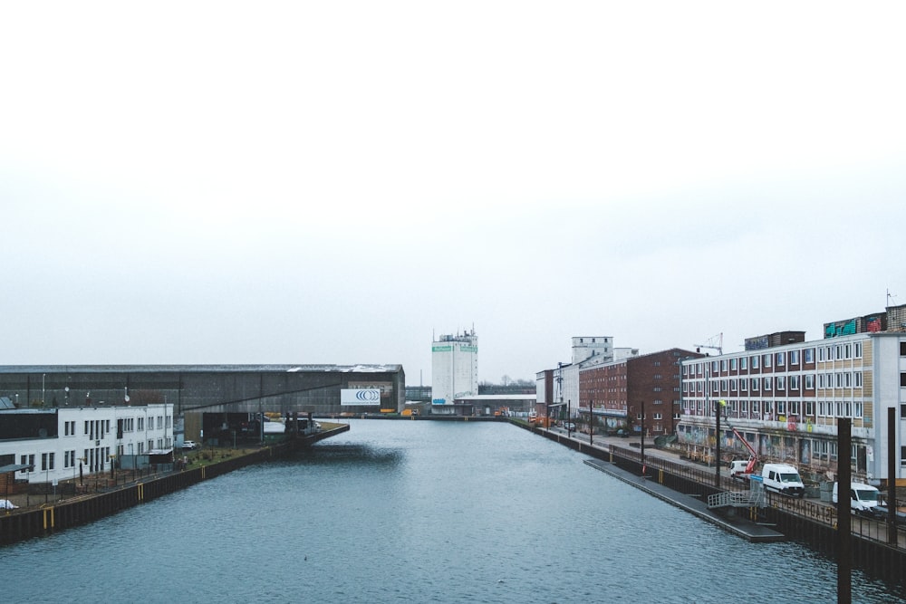 a river running through a city next to tall buildings