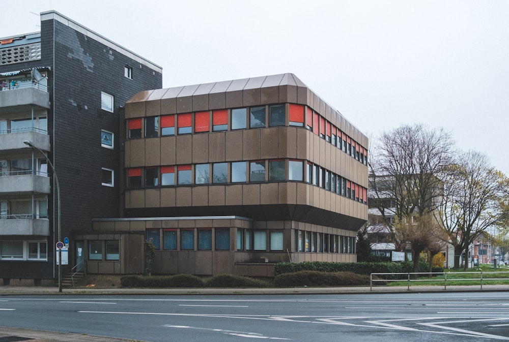 a large building with a lot of windows next to a street