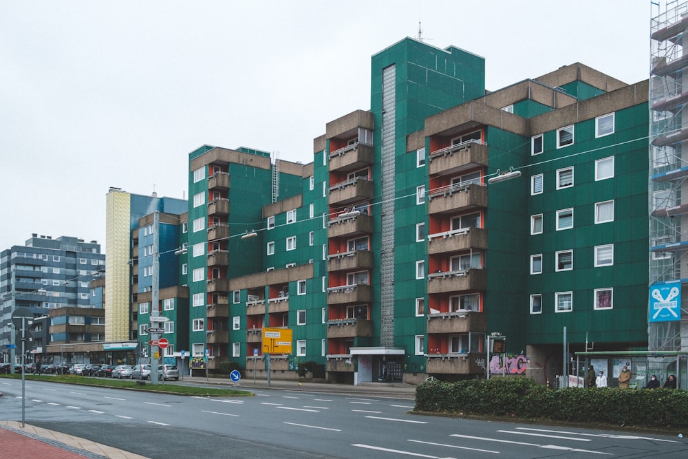 a large green building sitting next to a street