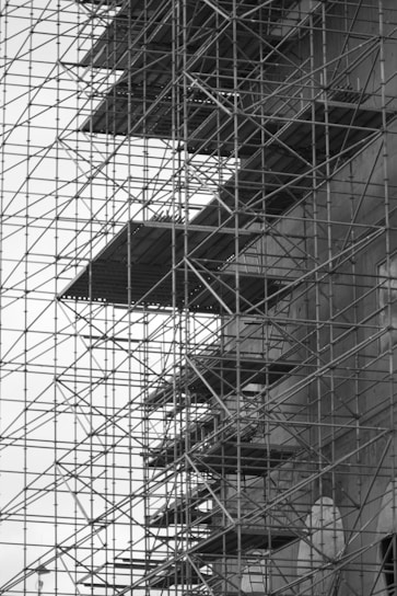 Photo of Peninsula Scaffolding team setting up a large scaffolding structure on a busy construction site.