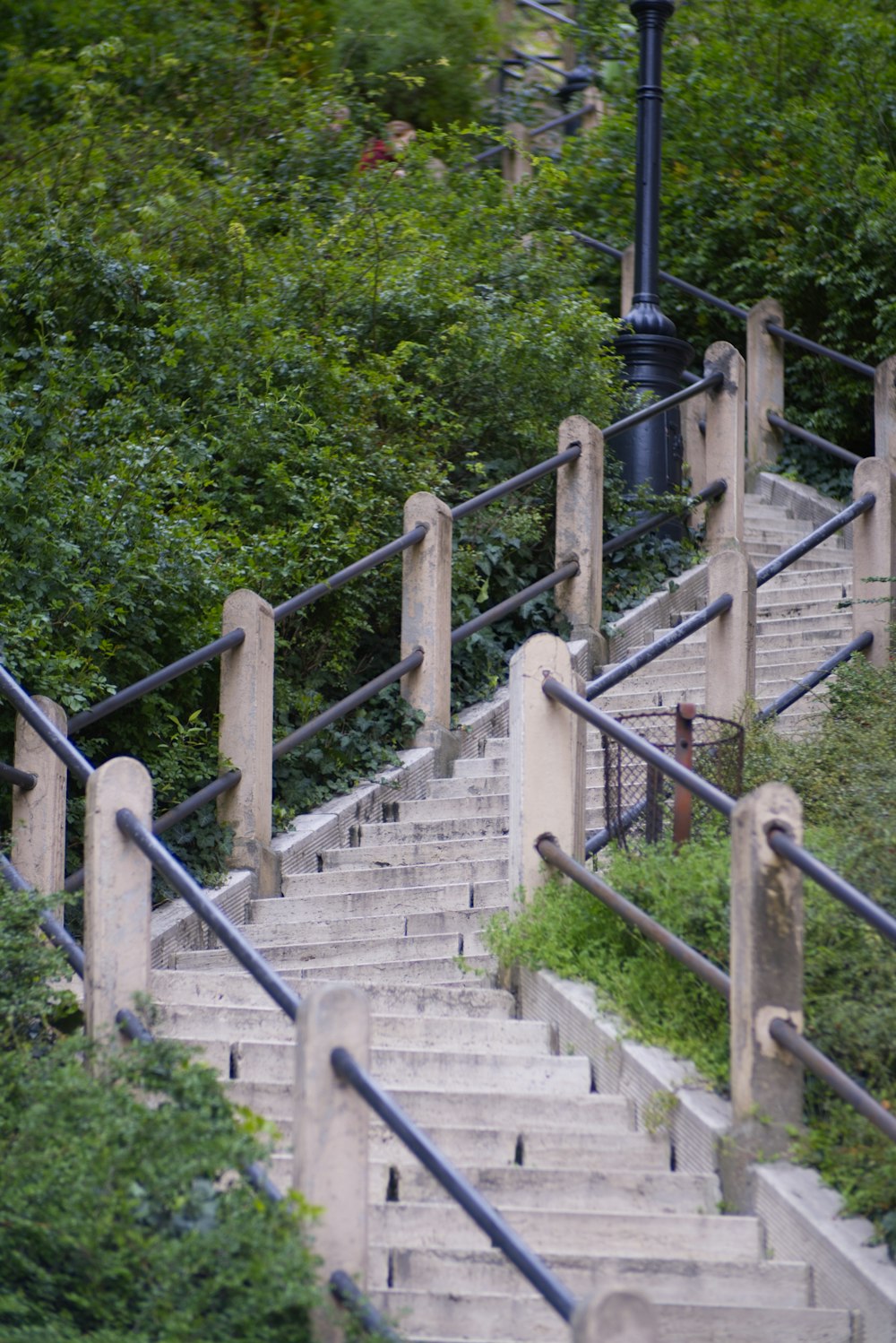 a street light sitting on the side of a set of stairs