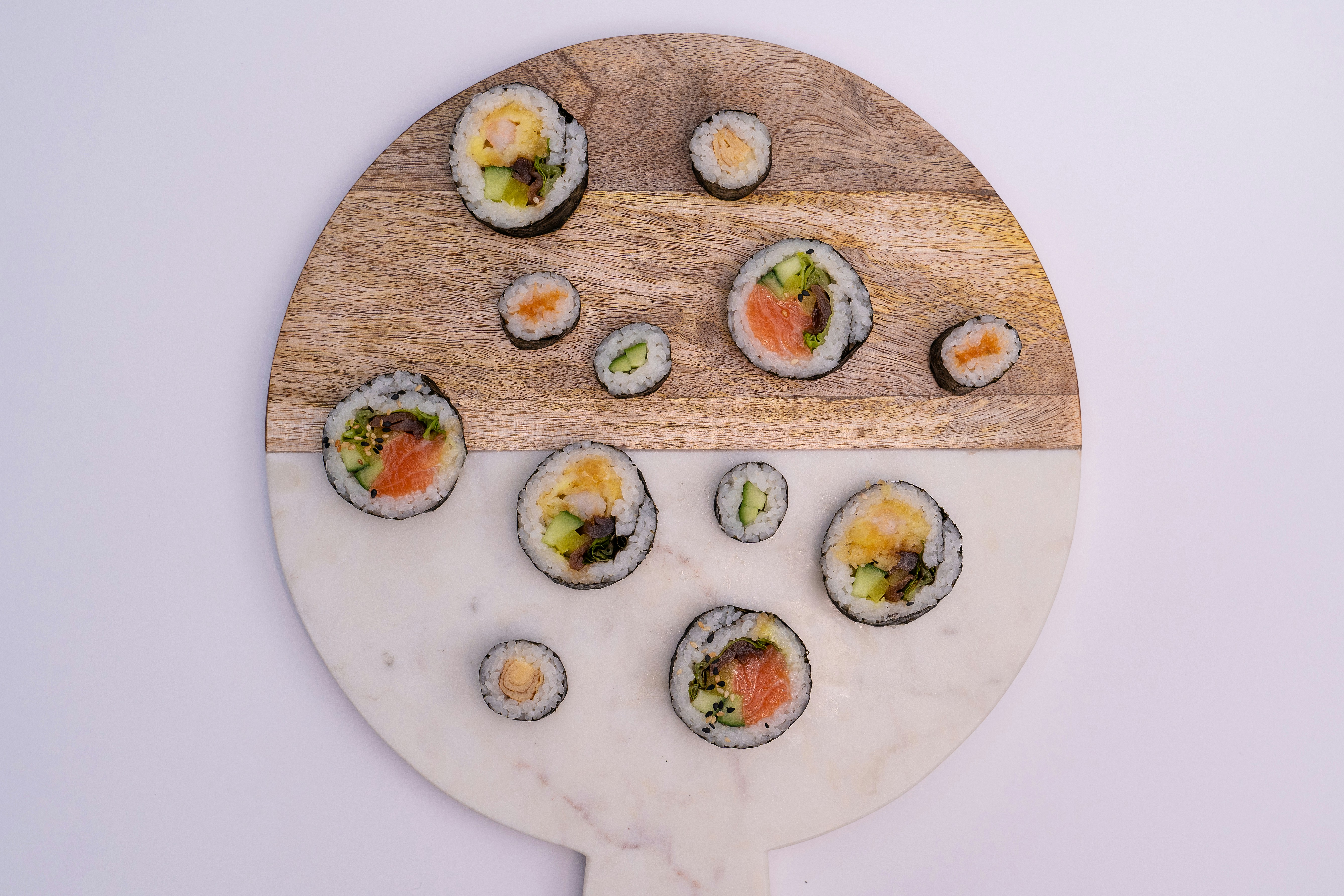 a wooden board with sushi on it