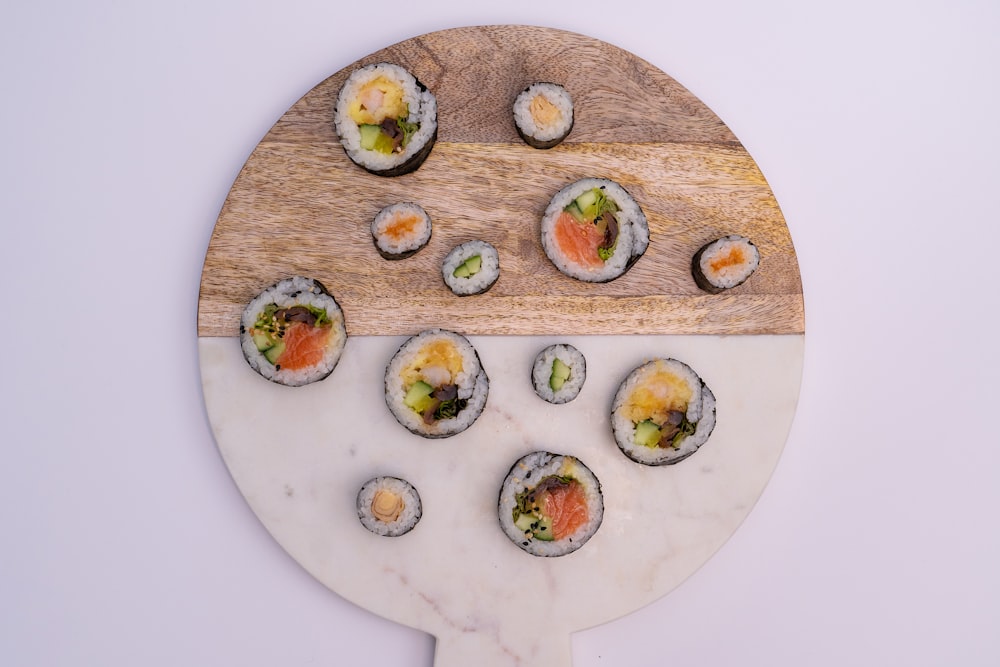 a wooden board with sushi on it