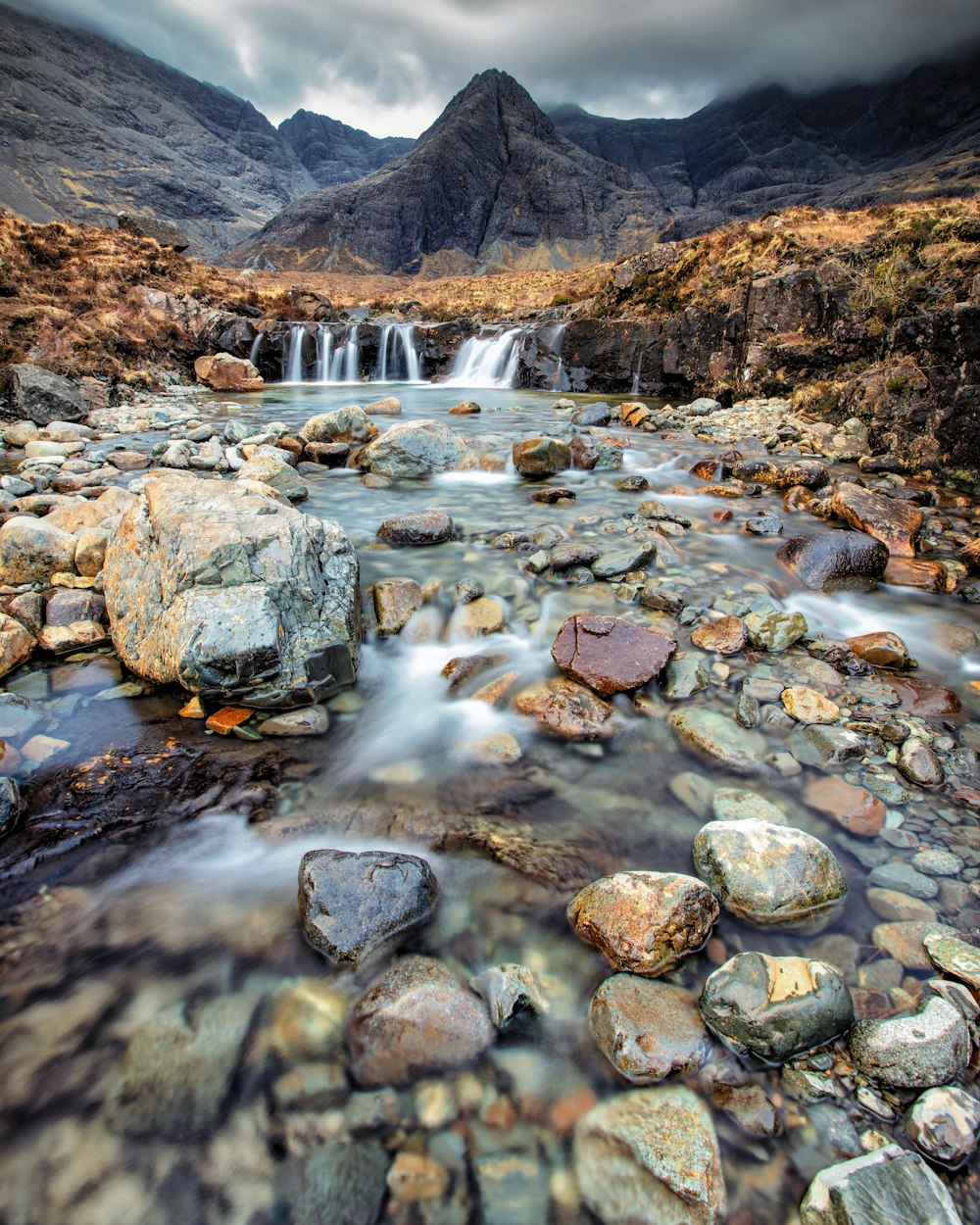 a mountain stream running through a rocky valley