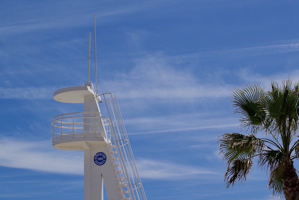 a tall white tower with a clock on it