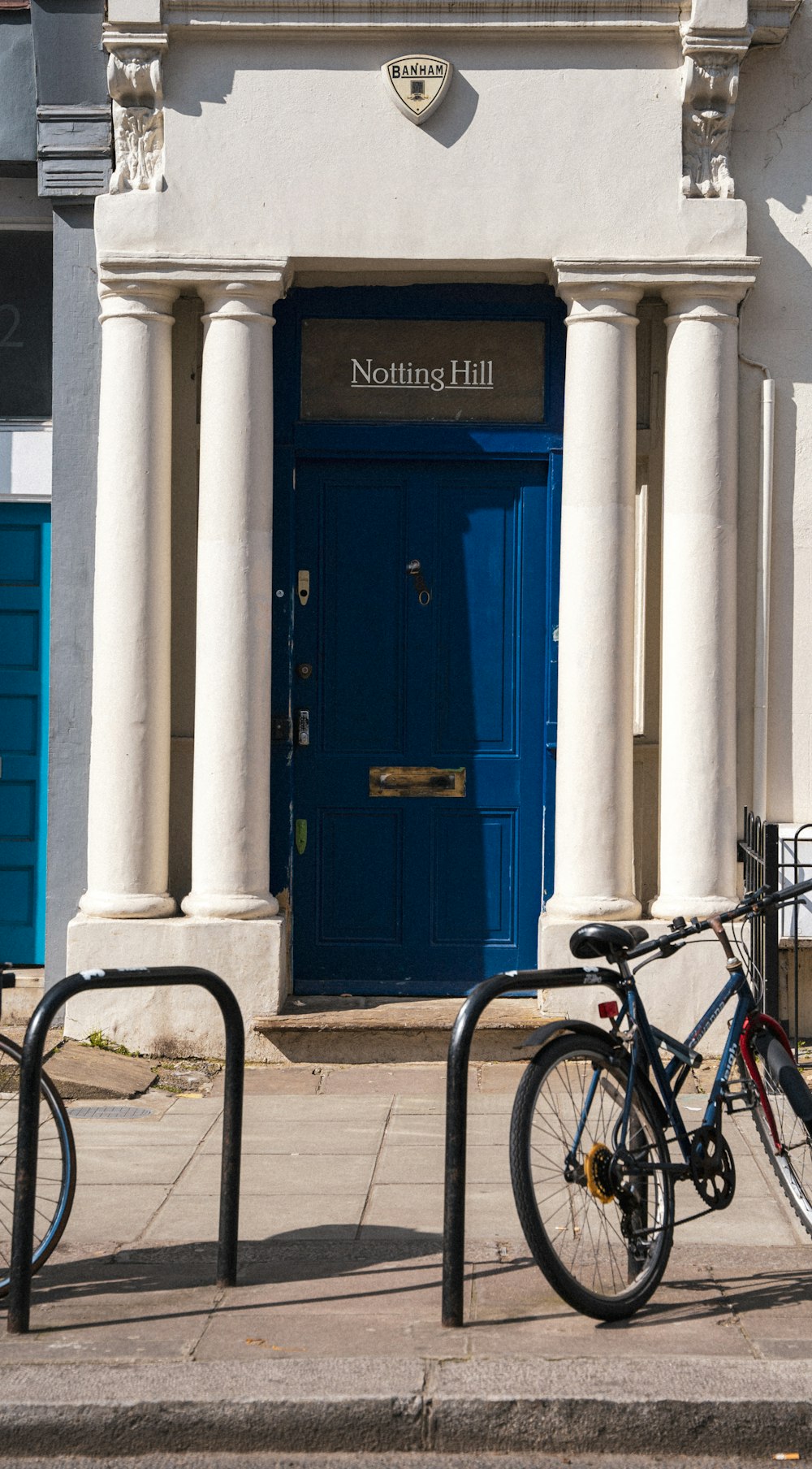 a bicycle parked in front of a blue door