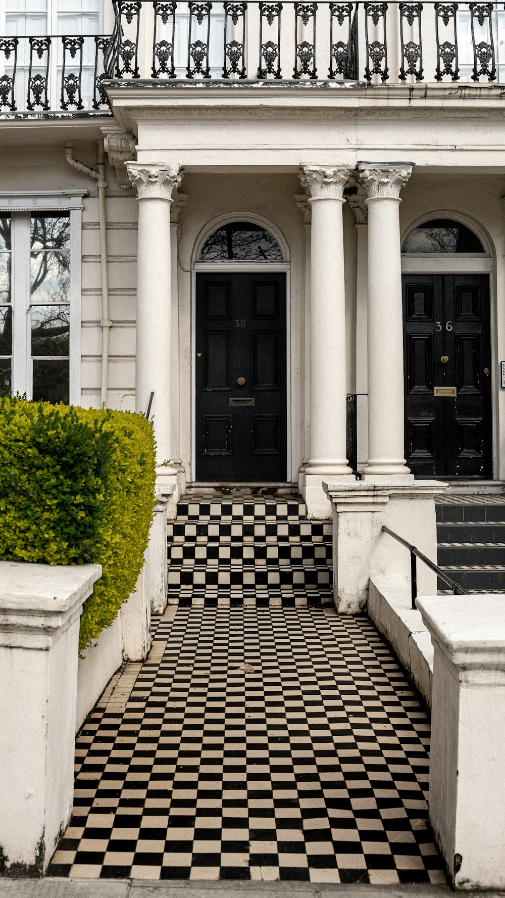 a black and white checkered floor in front of a building