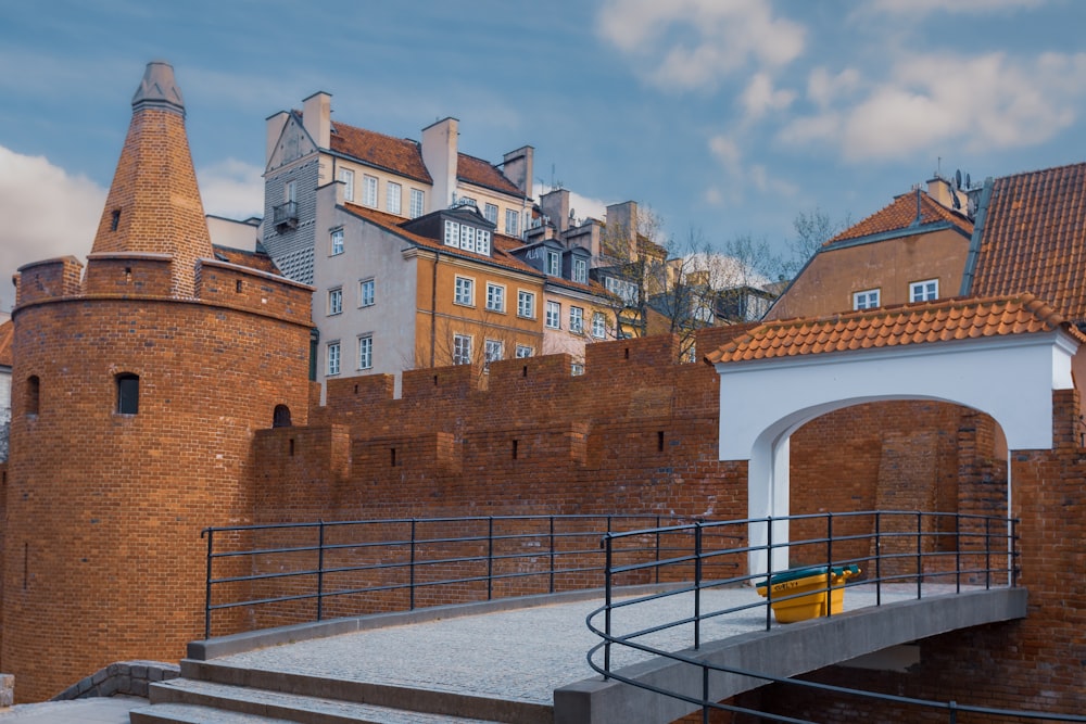 a brick wall with a bridge going over it