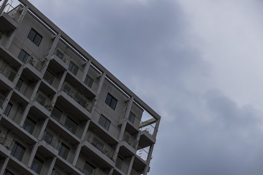 a tall building with balconies on the top of it