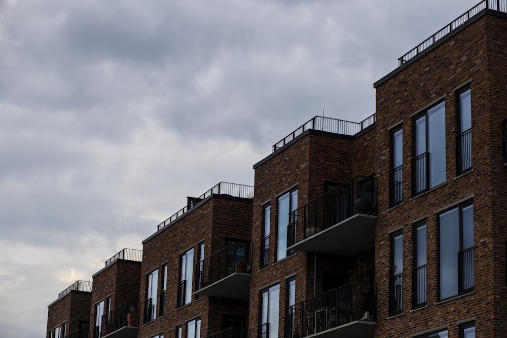 a row of brick apartment buildings with balconies
