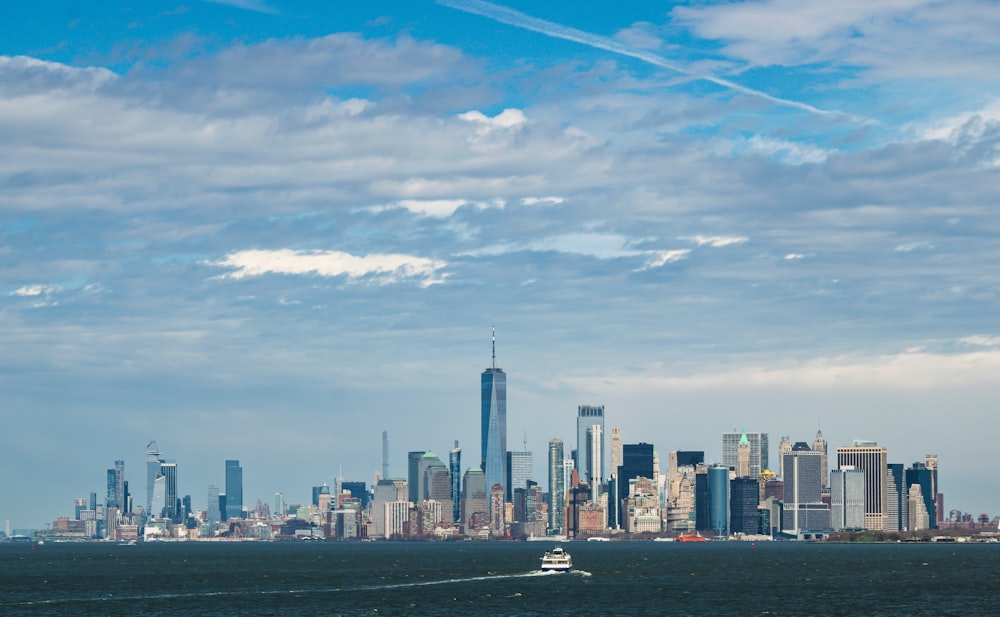 a boat in the water with a city in the background