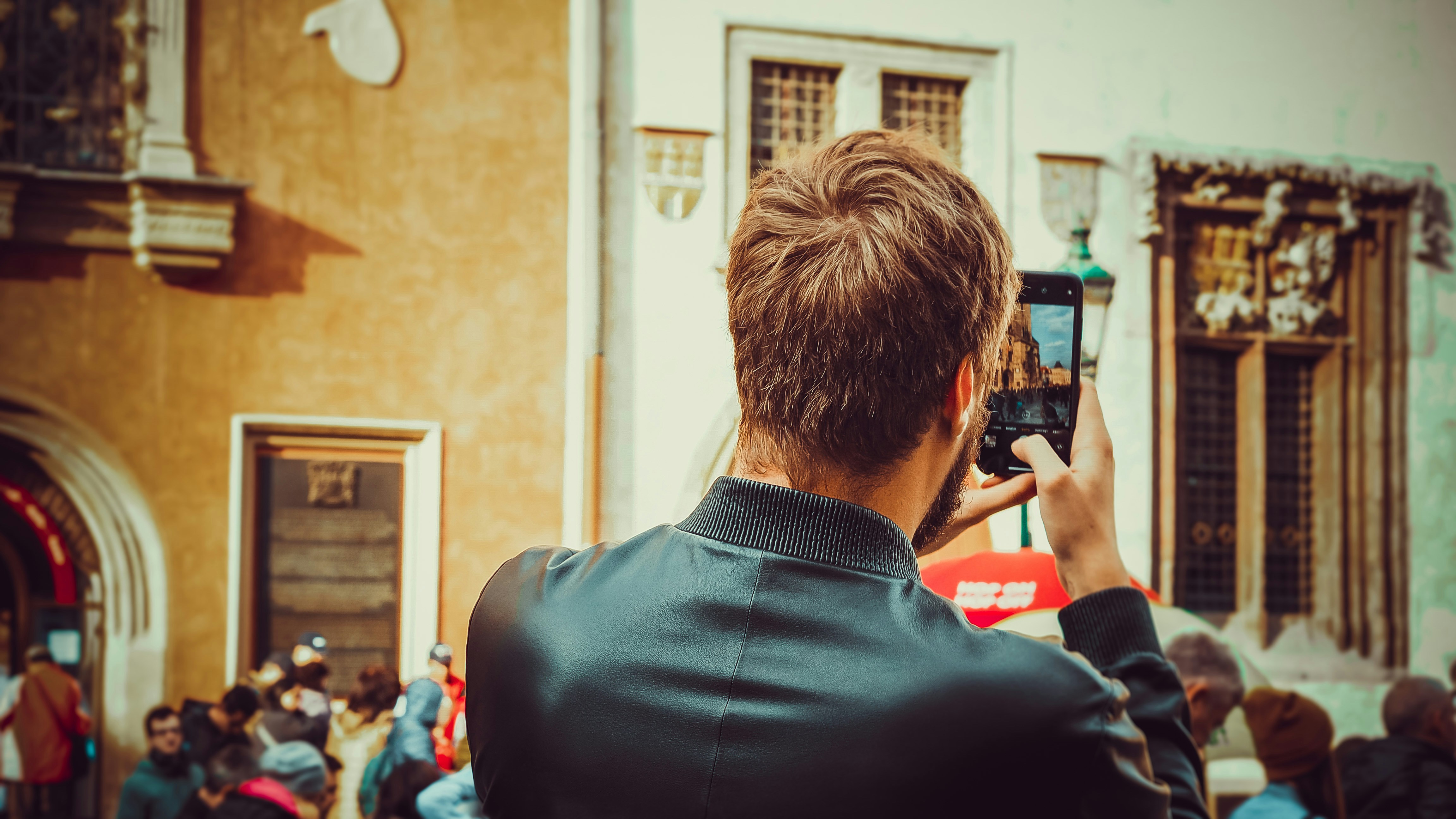a man taking a picture of a crowd of people