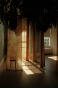 A calm and inviting therapy room with soft blue tones and natural light filtering through sheer curtains.