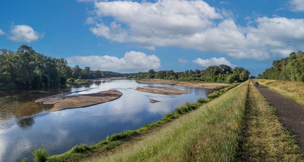 a river running through a lush green countryside