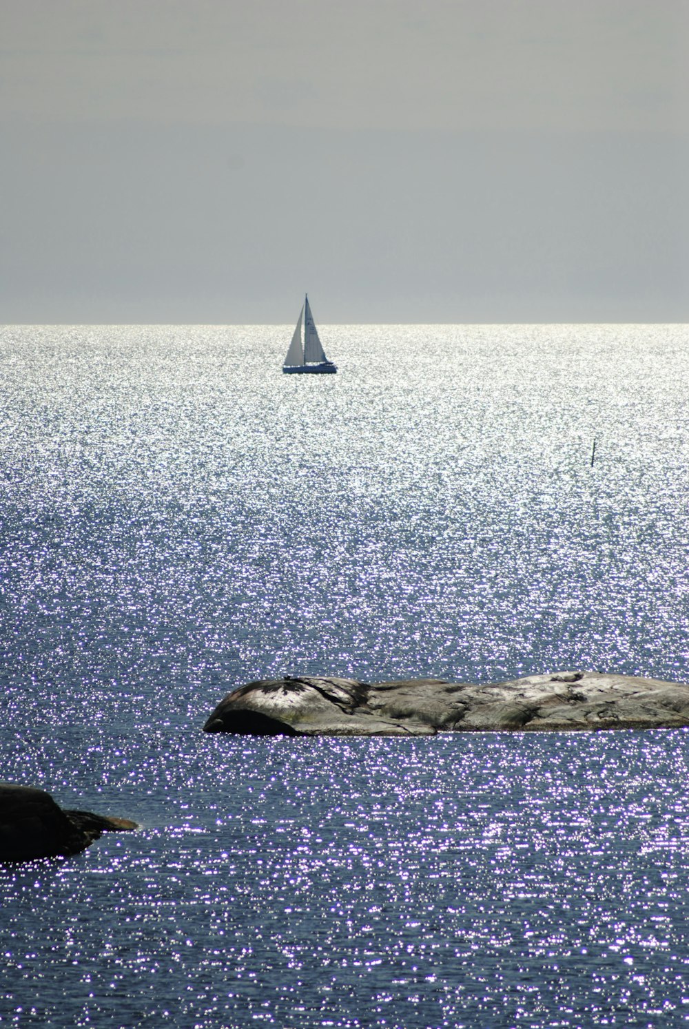 a sailboat is in the distance on the water