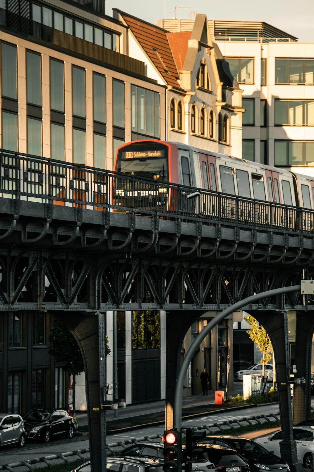 a train traveling over a bridge next to tall buildings