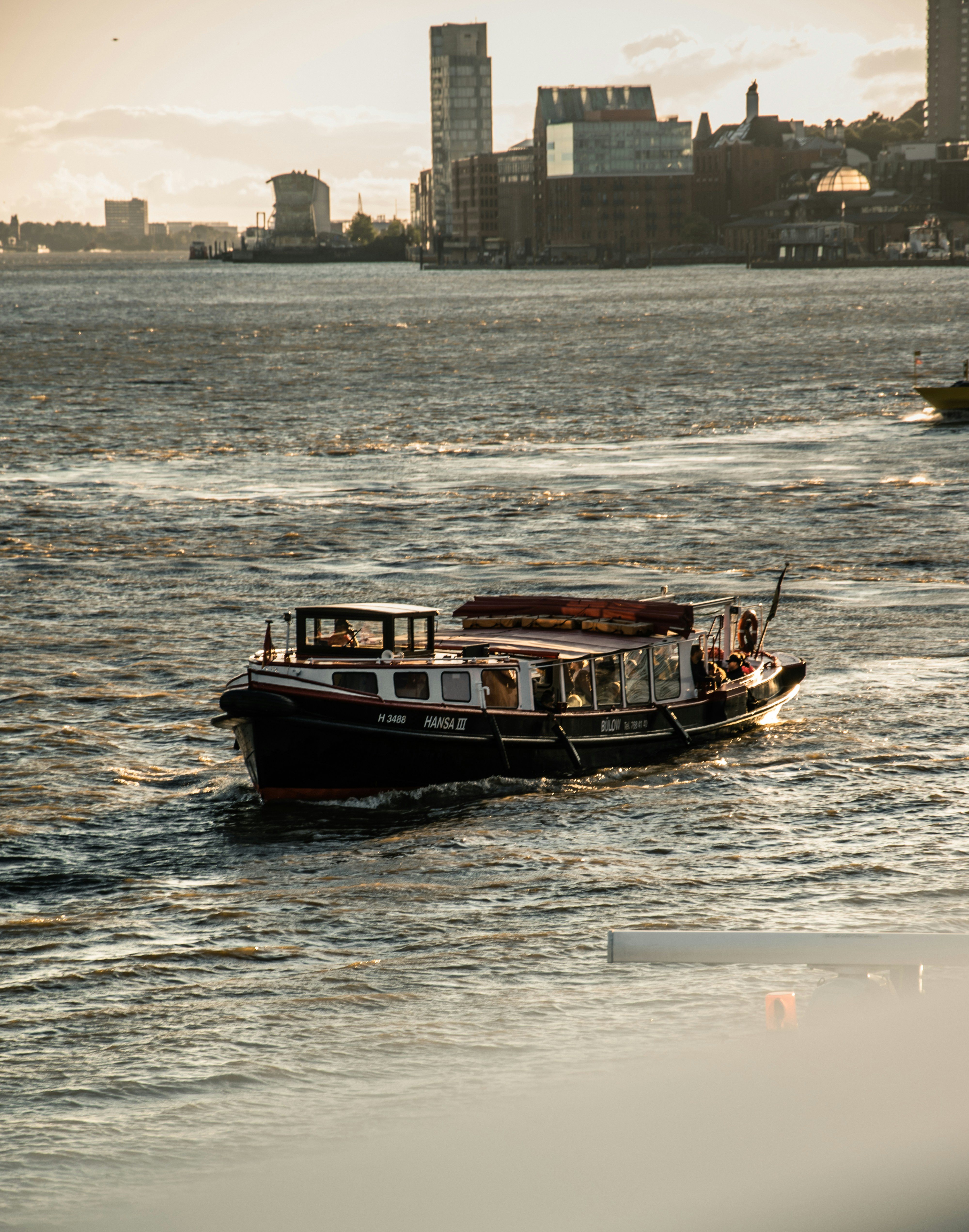 a boat is traveling on the water in front of a city
